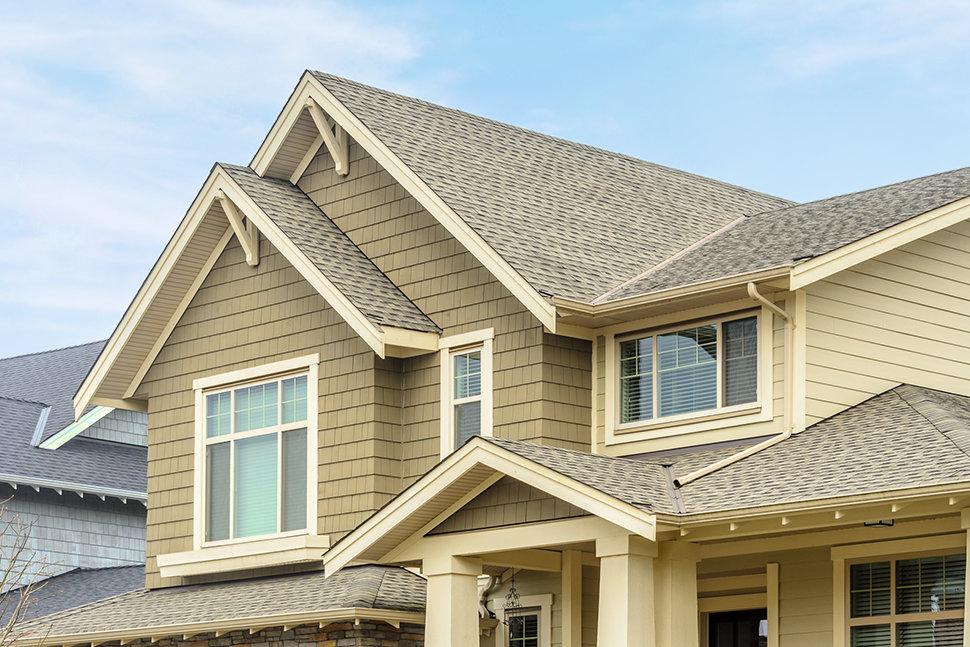 Exterior view of a two-story Fraser Valley home showcasing various modern replacement windows.